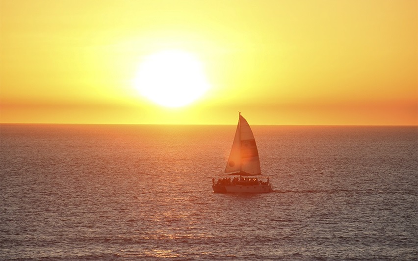 Sailing boat silhouetted against the sunset over the Indian Ocean in Broome, Western Australia.